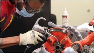 Pipefitter inspecting equipment
