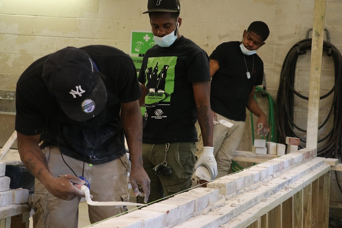 Students undergoing hands-on construction training in construction school