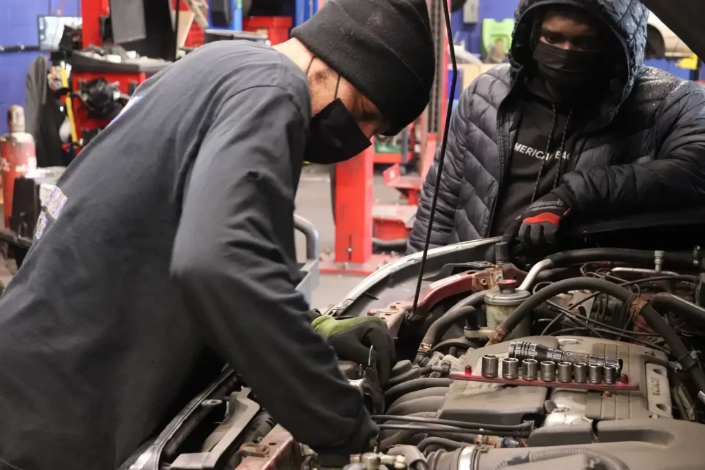 PTTI automotive graduate performing engine service at a Philadelphia area repair shop