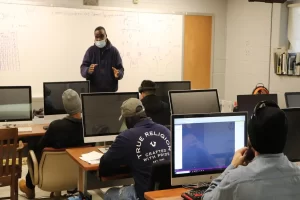 An instructor at PTTI explaining student benefits of trade school