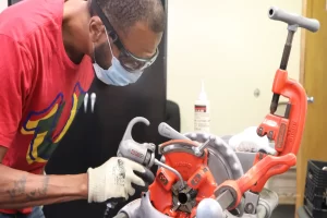 Prospective student examining skilled trade equipment