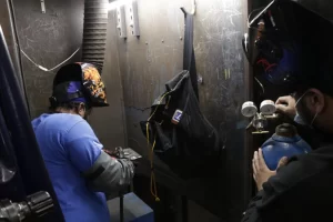 Students practicing in welding booths during hands-on trade training at PTTI in Philadelphia