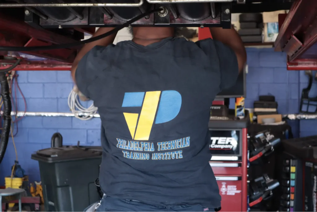 PTTI student exploring hands on training at automotive work station