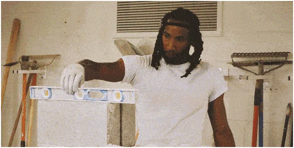 A blueprint for a project is examined by a construction student 