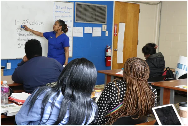 A teacher is teaching basics to trade students.