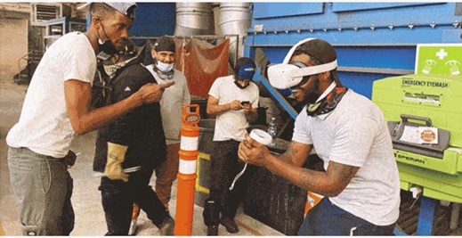 A group of welding students wearing high-tech gear