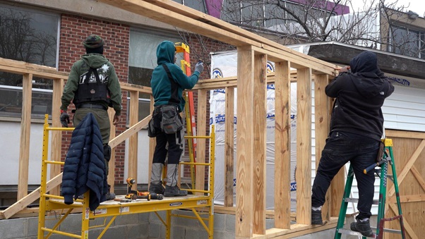 Construction workers building a structural frame on-site