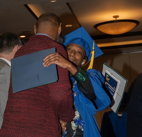 trade school graduation hug