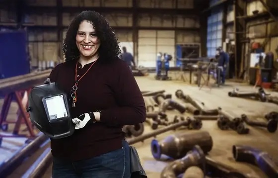 A student learns to work on metal welding projects at a workshop