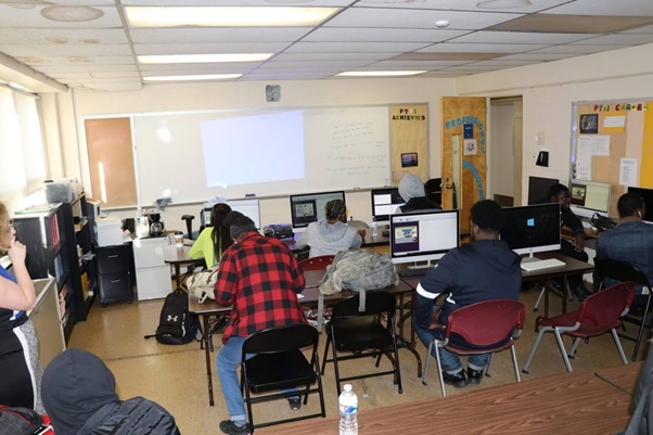 In a contemporary workshop, a student uses computerized diagnostic tools