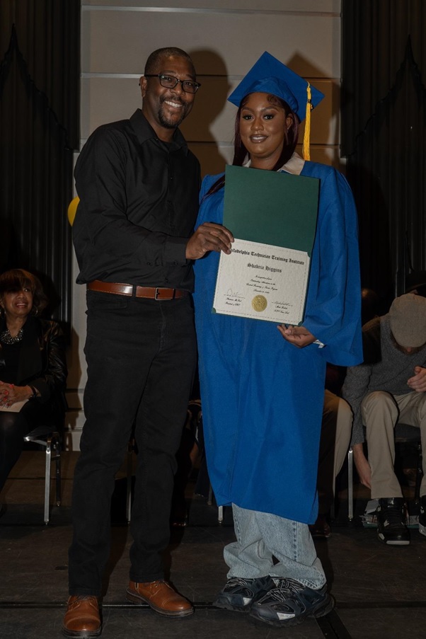 Robotics training graduate holding certification diploma