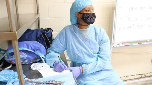 Adult student learning sterile processing skills during hands-on healthcare training at PTTI.