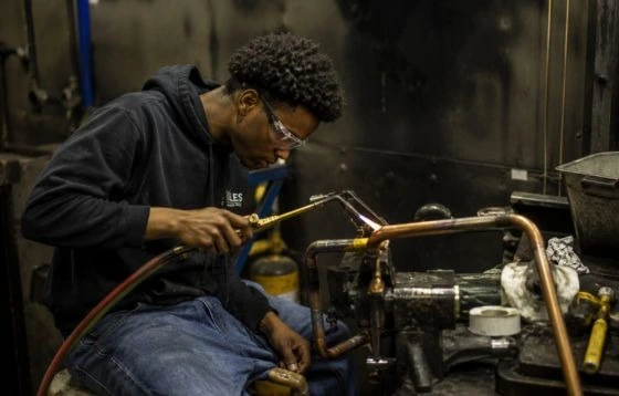 An HVAC Technician with a heating and cooling wiring system