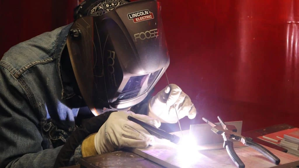 Student practicing welding at a Philadelphia trade school lab