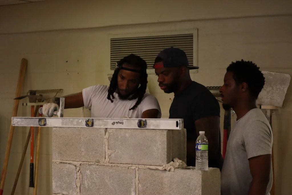 Masonry foreman leading a crew on a Philadelphia construction site