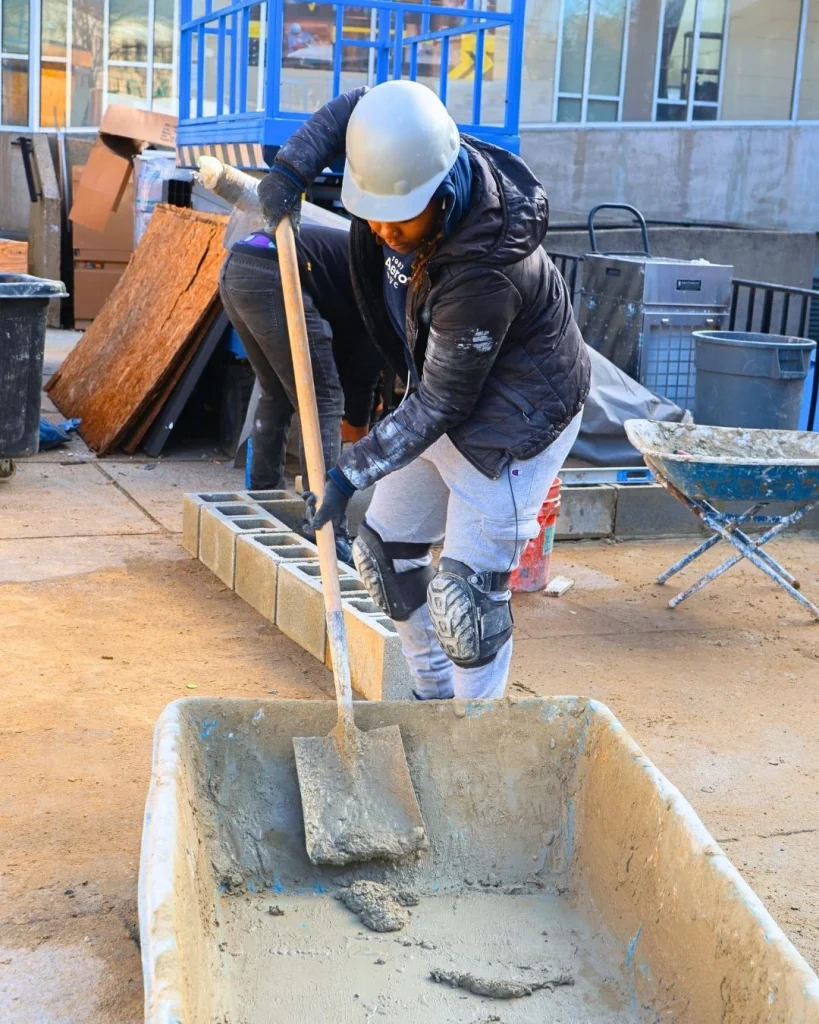 Masonry student laying brick during hands-on training at a Philadelphia trade school.